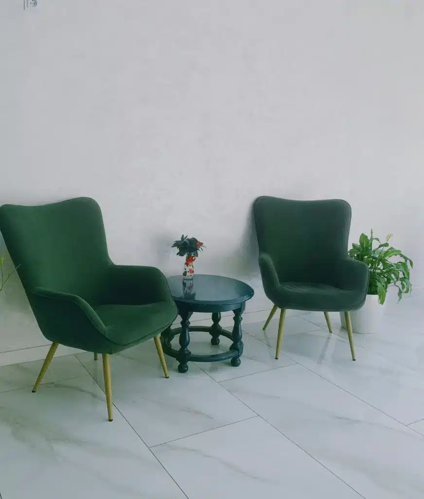 Two empty armchairs facing each other in a calm, warm room, symbolizing a safe and trusting space for psychotherapy sessions.